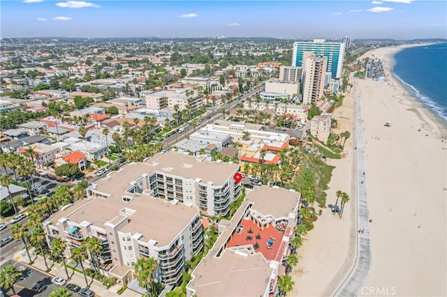 bird's eye view featuring a water view, a view of the beach, and a city view