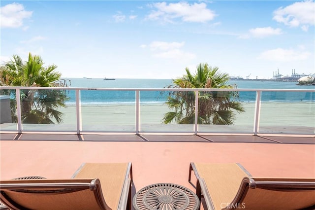 balcony with a view of the beach and a water view