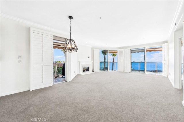 unfurnished living room with ornamental molding, carpet, and a fireplace with flush hearth