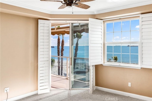 doorway to outside featuring a water view, crown molding, baseboards, and ceiling fan