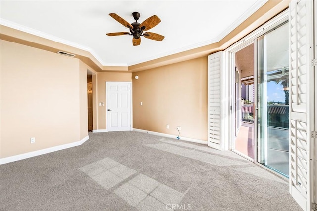 empty room featuring carpet floors, baseboards, visible vents, and ornamental molding