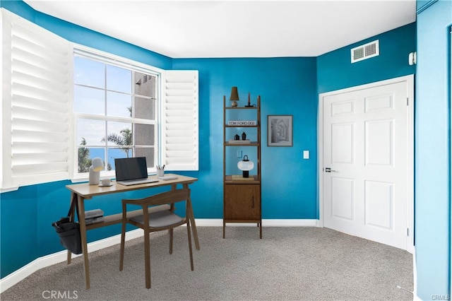 office featuring carpet floors, visible vents, and baseboards