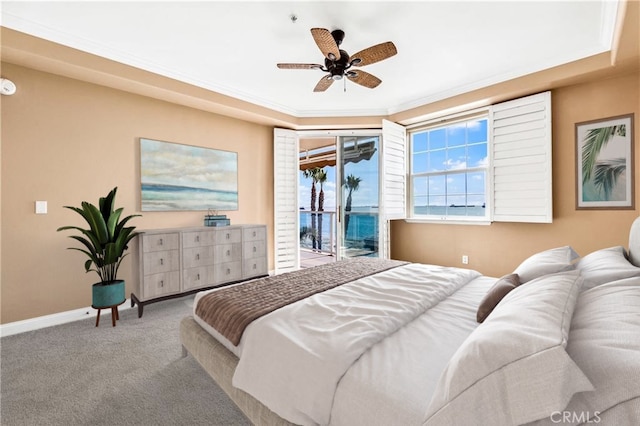 carpeted bedroom featuring access to exterior, crown molding, baseboards, and a ceiling fan