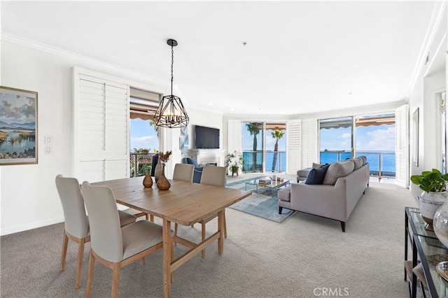 dining area featuring baseboards, ornamental molding, a wealth of natural light, and light colored carpet