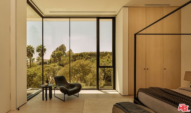 bedroom featuring light hardwood / wood-style flooring and multiple windows