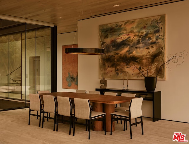 dining area featuring light wood-type flooring and wooden ceiling