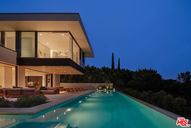 view of swimming pool featuring an outdoor living space and a patio