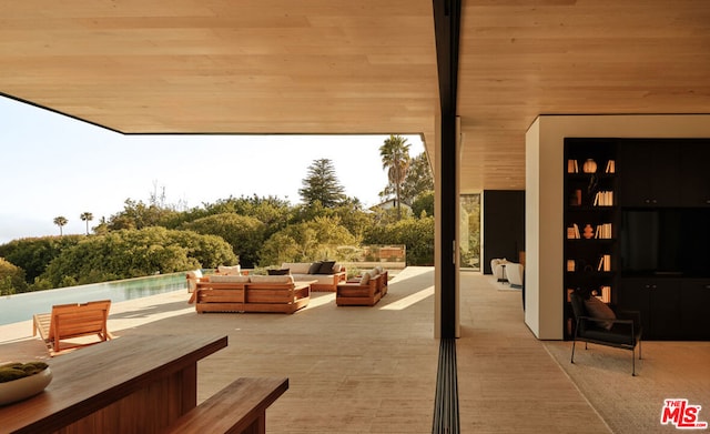 view of patio featuring a pool and outdoor lounge area