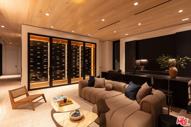 interior space with light hardwood / wood-style flooring, wooden ceiling, and sink