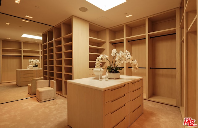 walk in closet featuring light colored carpet