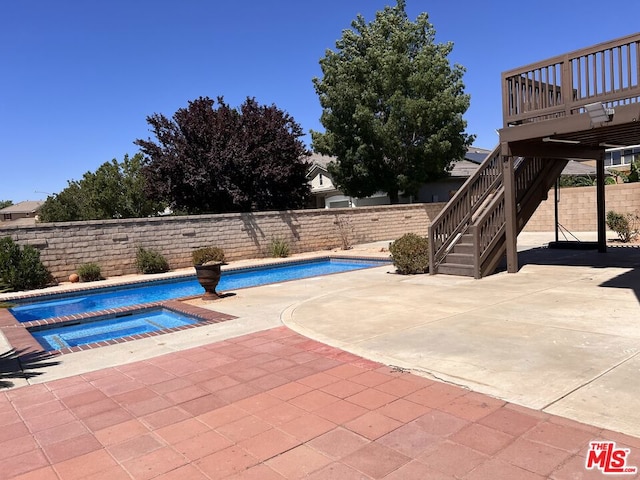 view of pool featuring an in ground hot tub and a patio