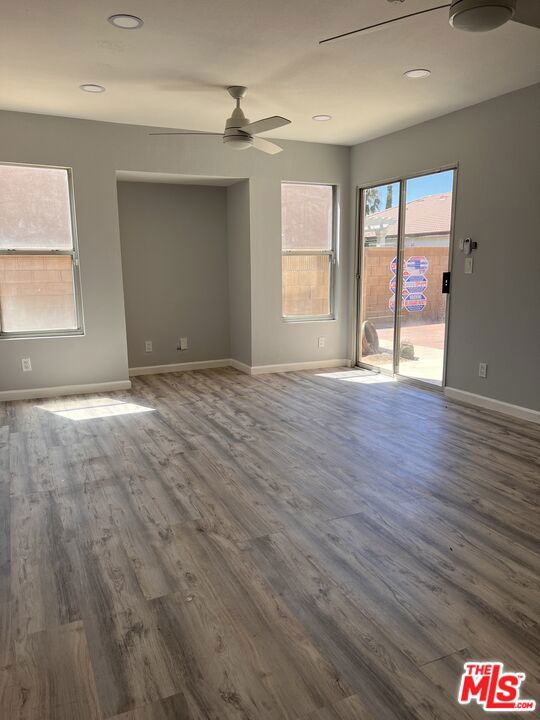 spare room featuring ceiling fan and wood-type flooring