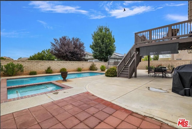 view of pool featuring an in ground hot tub, grilling area, and a patio