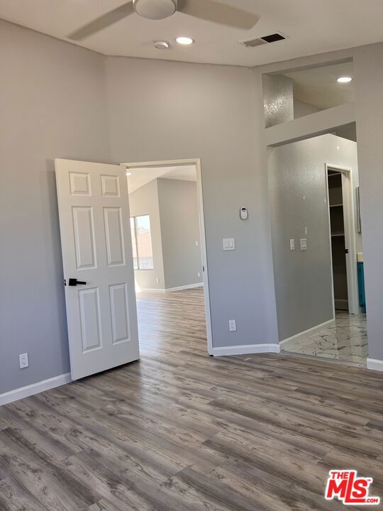 spare room featuring hardwood / wood-style flooring and a high ceiling