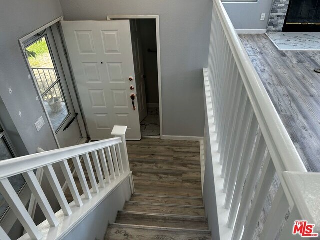 stairway featuring wood-type flooring