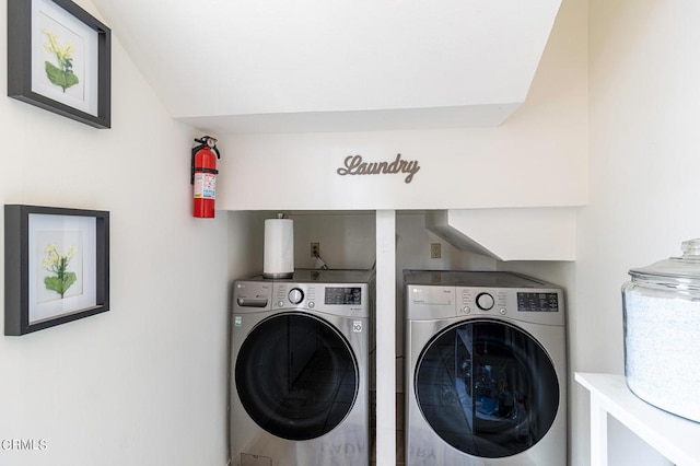 clothes washing area featuring separate washer and dryer