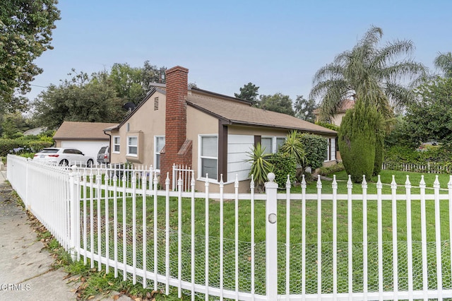 view of side of property with a lawn