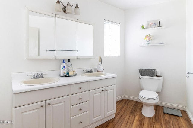 bathroom featuring vanity, toilet, and wood-type flooring