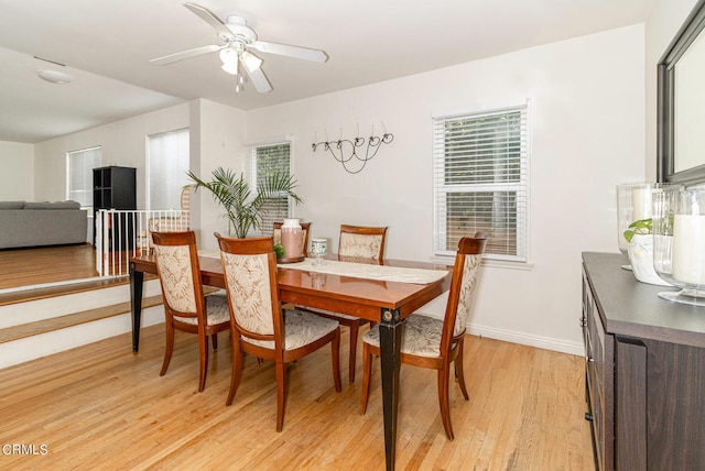 dining room with light wood-type flooring, a wealth of natural light, and ceiling fan