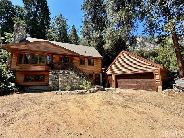 log-style house with a garage