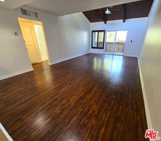 empty room featuring lofted ceiling with beams, ceiling fan, and dark hardwood / wood-style floors