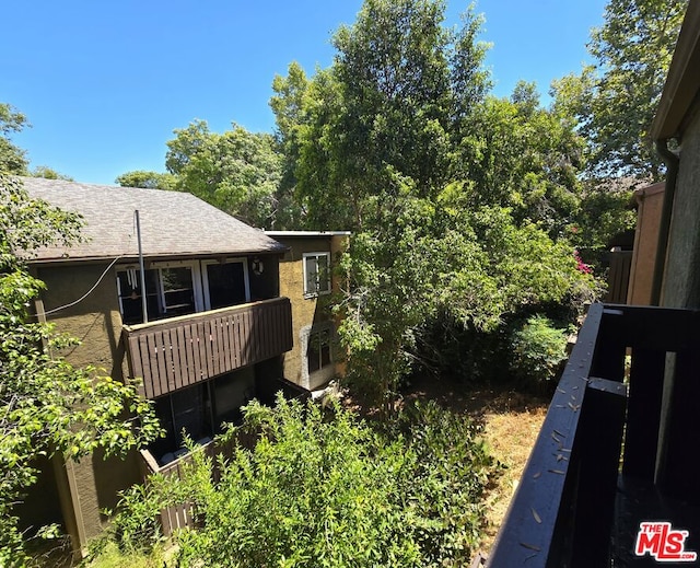 view of side of home with a balcony