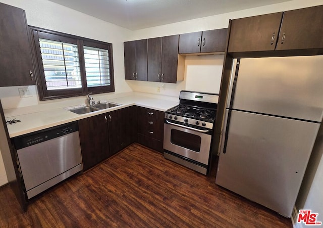 kitchen with dark brown cabinets, stainless steel appliances, sink, and dark hardwood / wood-style flooring