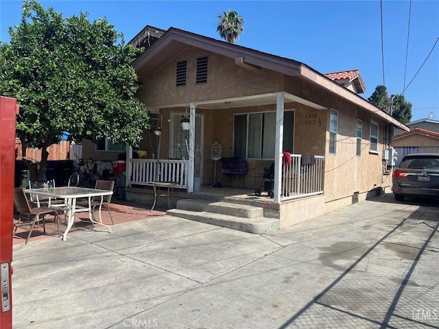 view of front of house with a porch and a patio