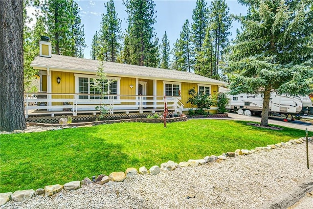 ranch-style house with a front lawn and covered porch