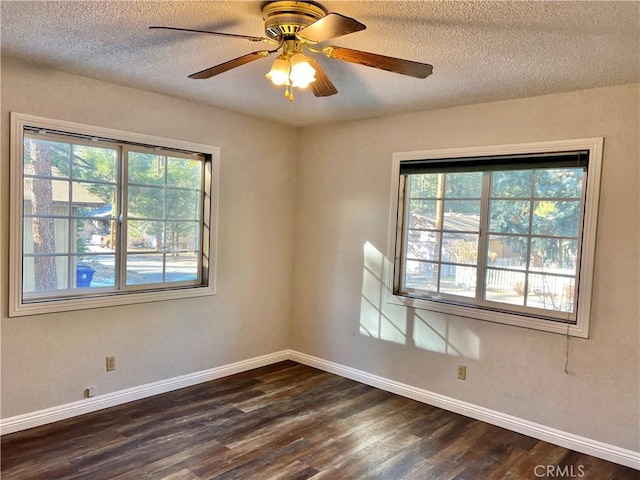 spare room featuring a textured ceiling, ceiling fan, and dark wood-type flooring