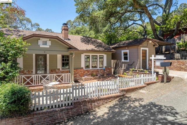 rear view of house with covered porch