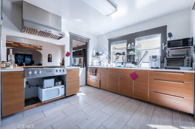 kitchen with wall chimney range hood