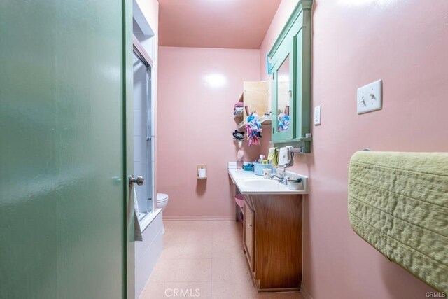 bathroom featuring walk in shower, vanity, and toilet