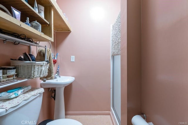 bathroom with toilet and walk in shower