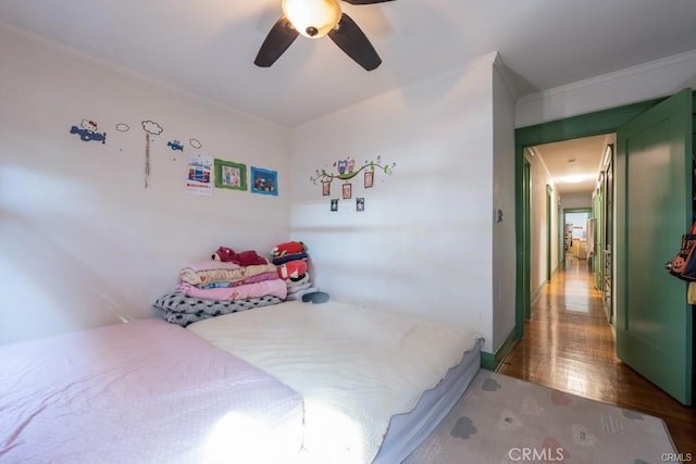 bedroom with crown molding and ceiling fan