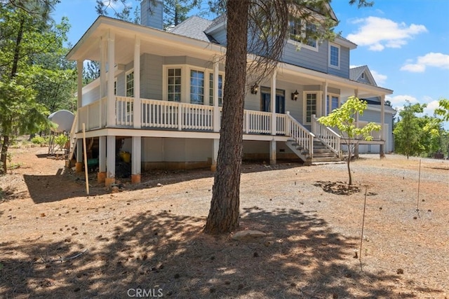 rear view of property featuring covered porch