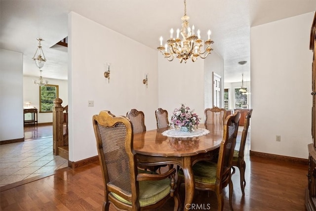 dining area featuring a chandelier and dark hardwood / wood-style flooring