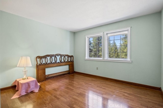 bedroom with hardwood / wood-style floors