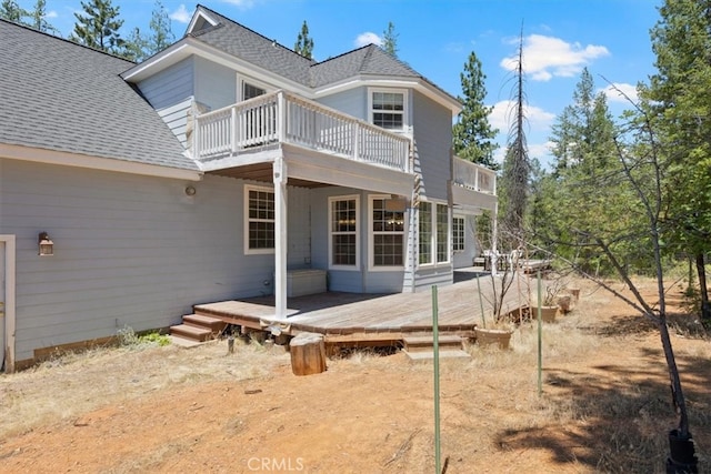 rear view of house featuring a deck