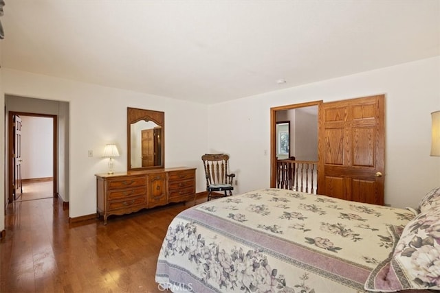 bedroom with dark hardwood / wood-style flooring