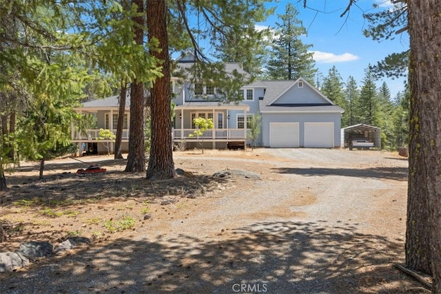 view of front of property with covered porch and a garage