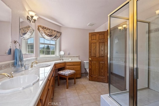 bathroom featuring vanity, a shower with shower door, toilet, and tile patterned flooring