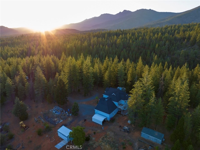 aerial view at dusk featuring a mountain view