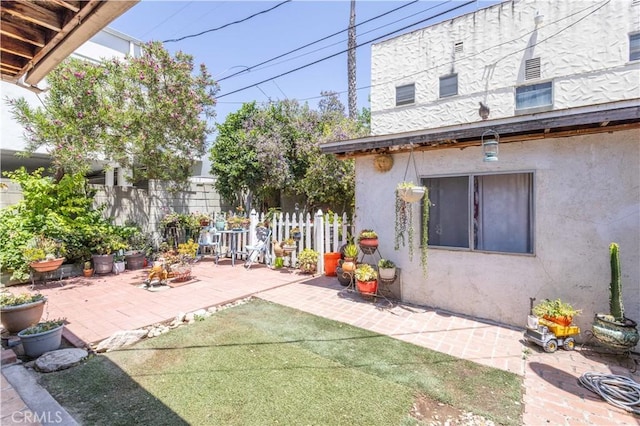 view of patio featuring fence