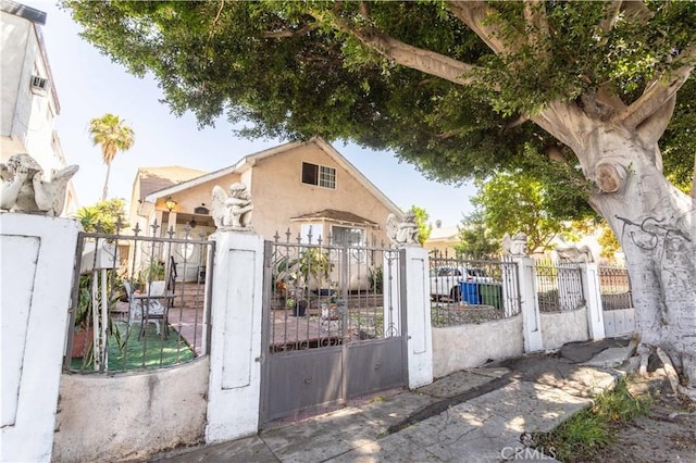 view of gate with a fenced front yard