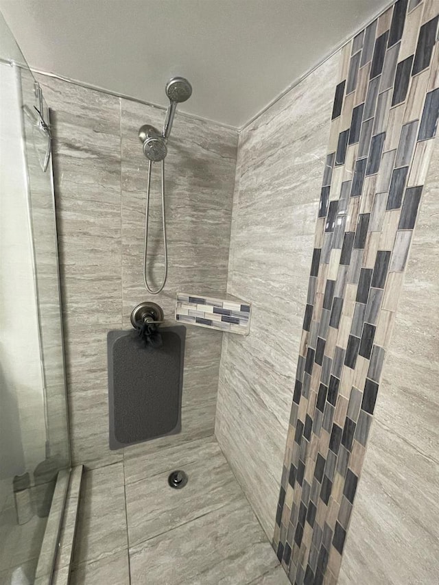 bathroom with tiled shower