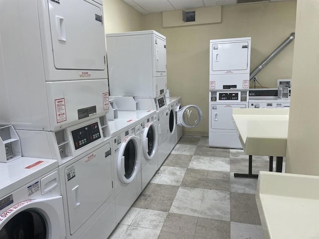 laundry room with sink, stacked washer / drying machine, and independent washer and dryer