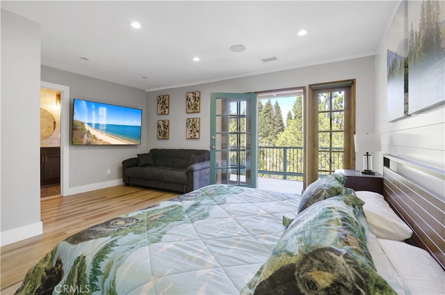 bedroom with light hardwood / wood-style flooring, access to exterior, ornamental molding, and ensuite bathroom