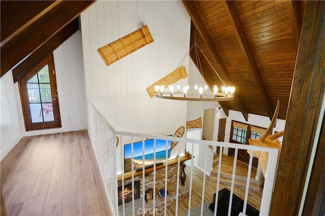 interior space featuring wood ceiling, wood-type flooring, vaulted ceiling with beams, and a chandelier