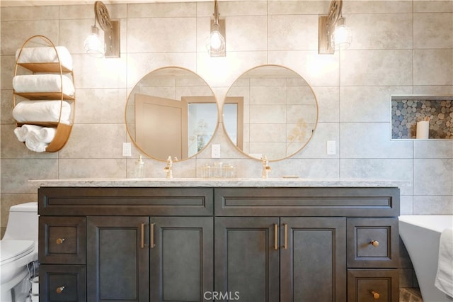 bathroom with vanity, tile walls, toilet, and decorative backsplash